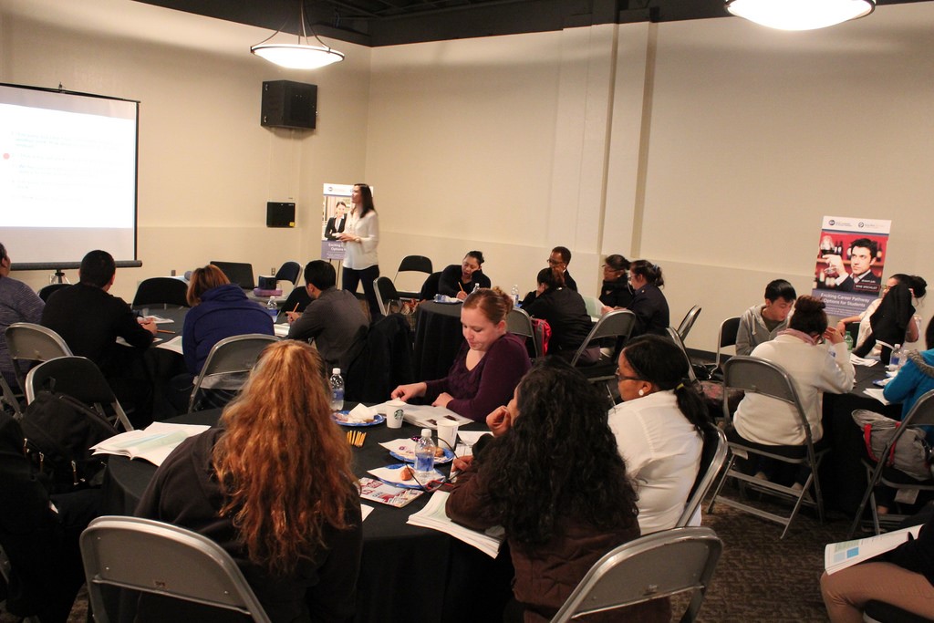 Business owners and employees learning how to use the ID Checking Guide in a conference room